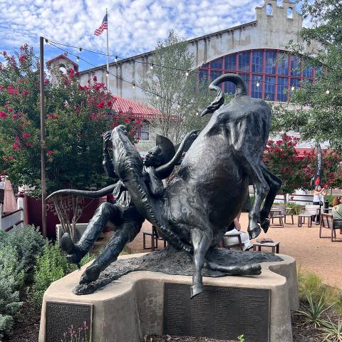 Bronze statue of Bill Pickett wrestling a Texas Longhorn.